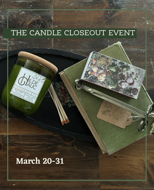 candle with a book matches and wick trimmer